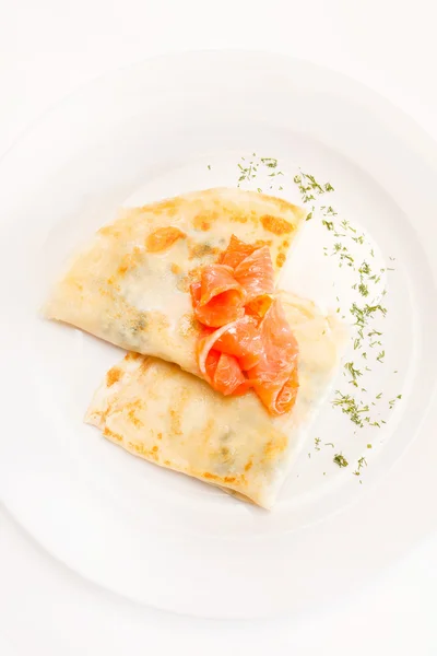 Pancakes with salmon on plate — Stock Photo, Image