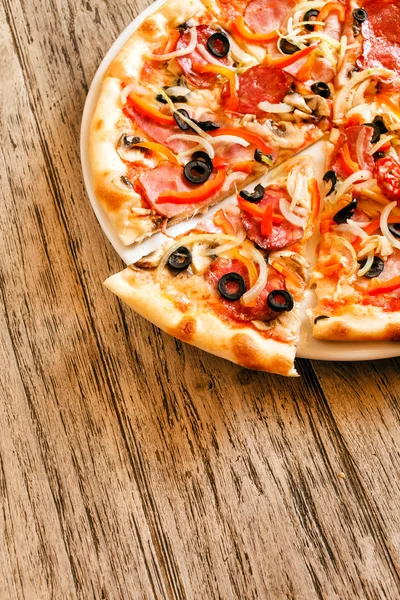 Tasty pizza on wooden — Stock Photo, Image