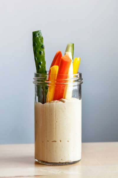 Hummus with vegetables in glass