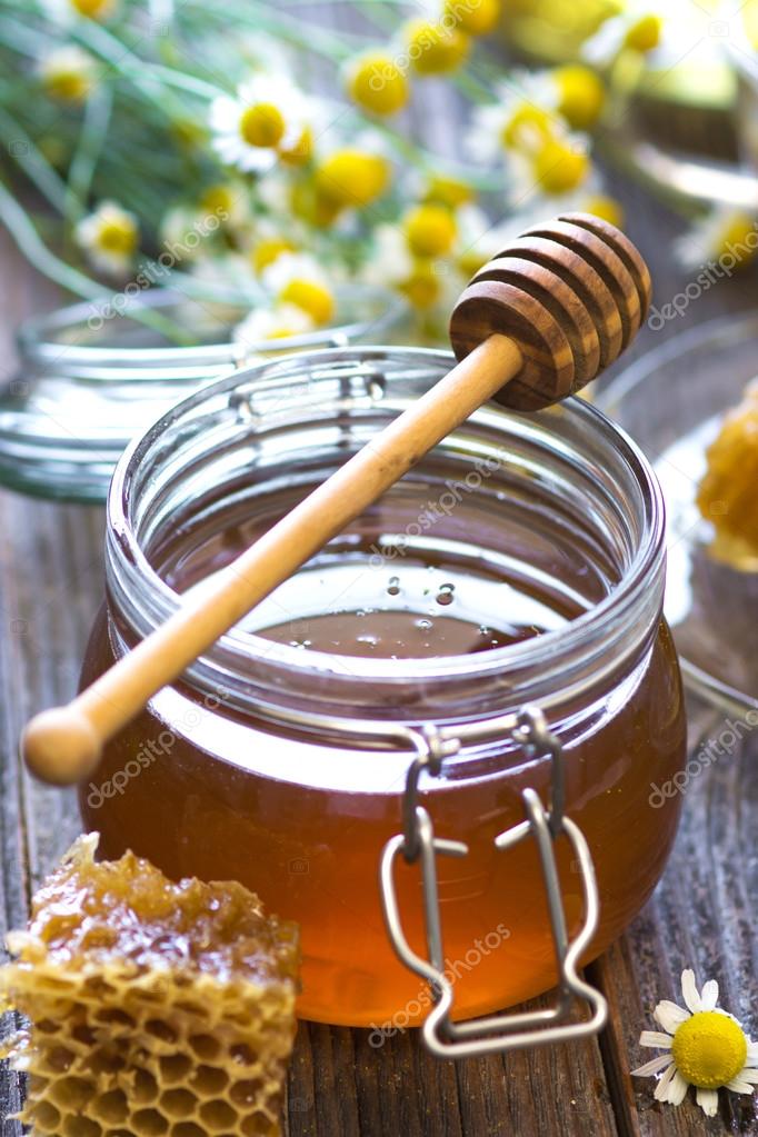 Glass jar with golden honey