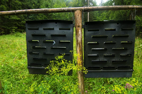 Metal plates hanging on wooden fence — Stock Photo, Image