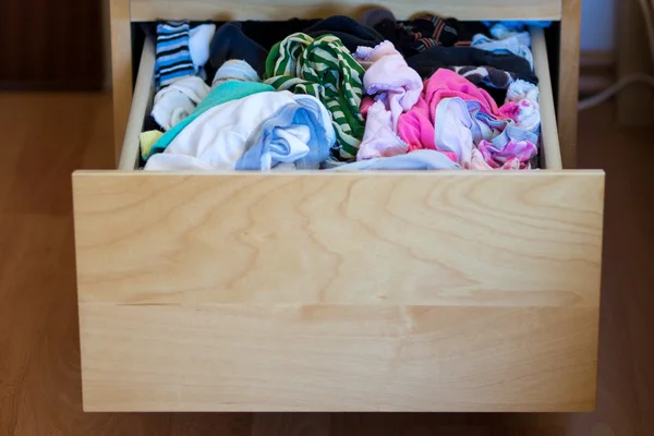 Messy clothes in open drawer — Stock Photo, Image