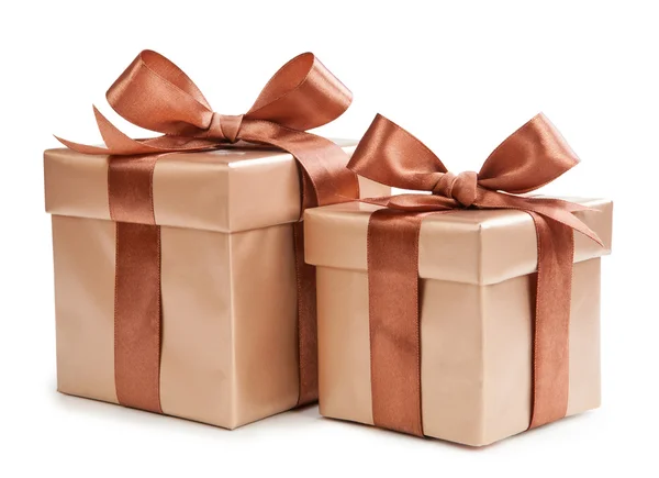 Gold box with gifts and brown bow — Stock Photo, Image
