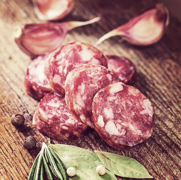 Sliced sausage with spices — Stock Photo, Image