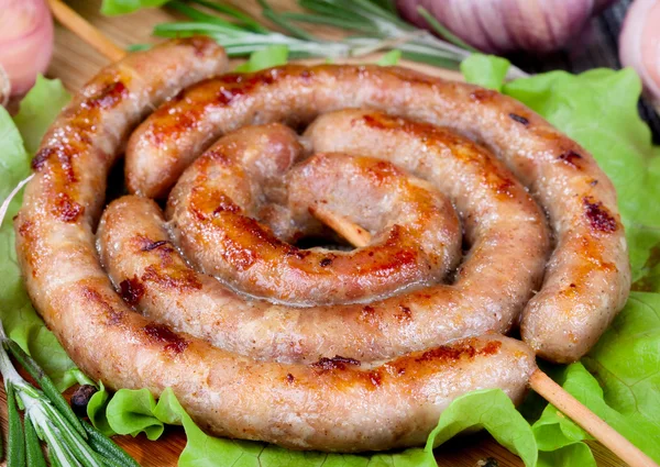 Sausage on lettuce leaves — Stock Photo, Image