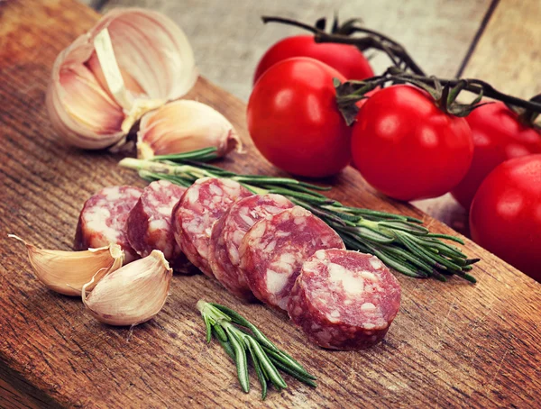 Sliced sausage, spices and garlic — Stock Photo, Image