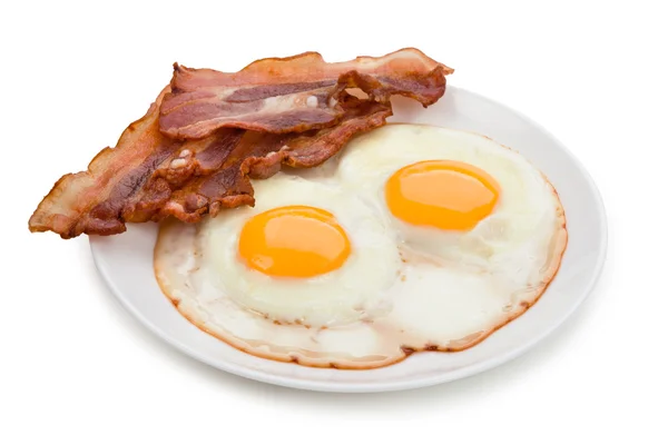 Plate with fried eggs and bacon Royalty Free Stock Images