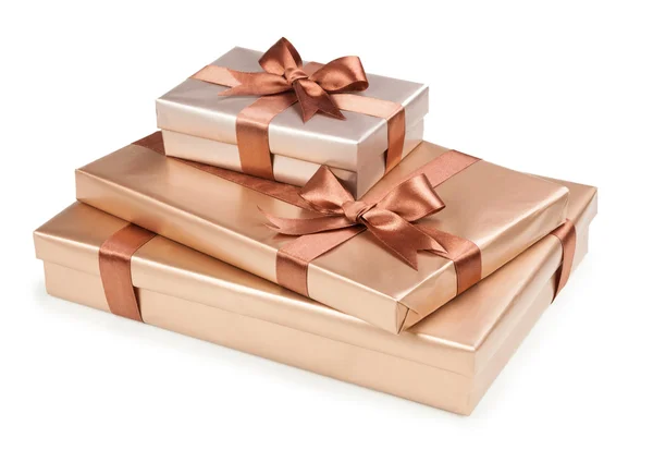 Gold box with gifts and brown bow — Stock Photo, Image