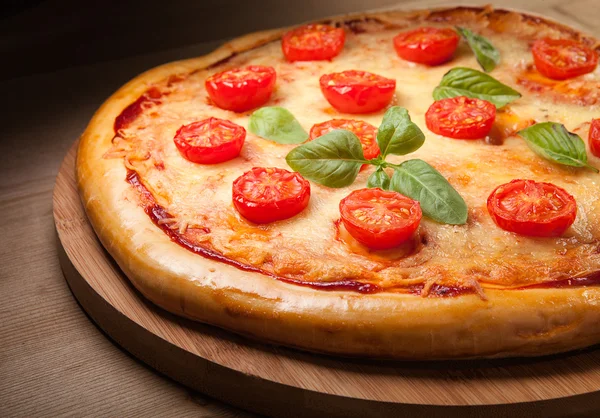 Fresh pizza on wood — Stock Photo, Image