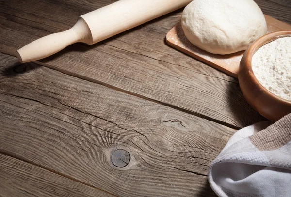 Masa, harina y rodillo en una tabla vieja . — Foto de Stock