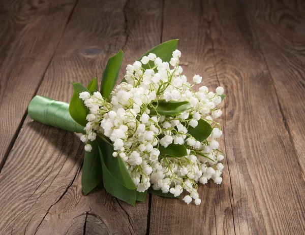 Bouquet of lilies of the valley on the old board — Stock Photo, Image