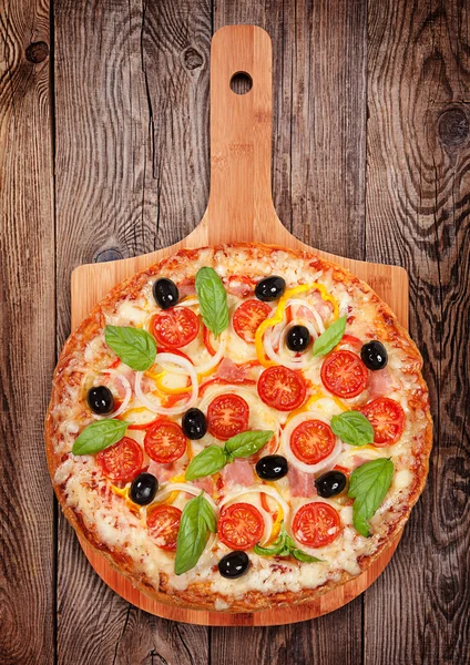 Tasty delicious pizza with salami on the old boards — Stock Photo, Image