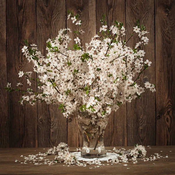 Beautiful bouquet of cherries in a vase on the old boards — Stock Photo, Image