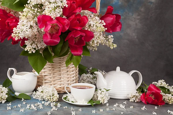 Bukett av rosor med lila och te koppar för te på bordet — Stockfoto