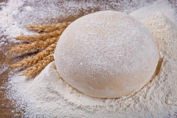 Flour and ears on old board — Stock Photo, Image