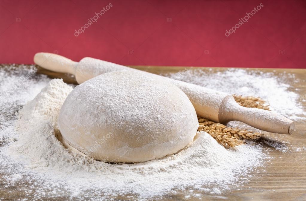 wooden rolling pin with dough