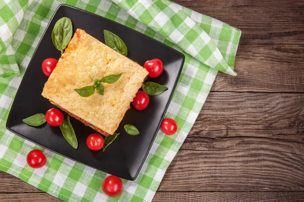 Tasty lasagna on an old table — Stock Photo, Image