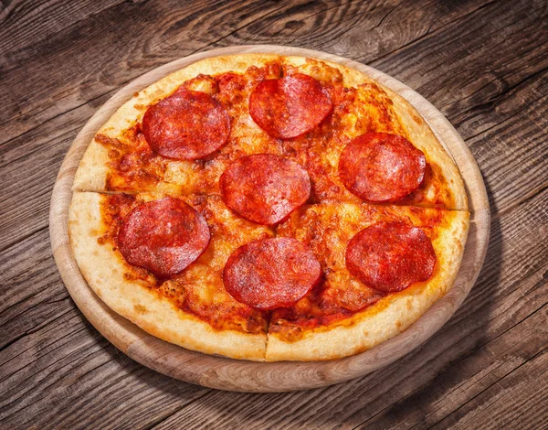 Pizza with salami on the old table — Stock Photo, Image