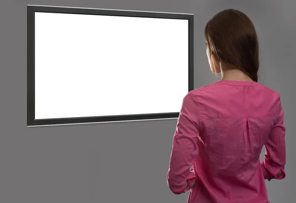 Woman looking at blank tv screen — Stock Photo, Image