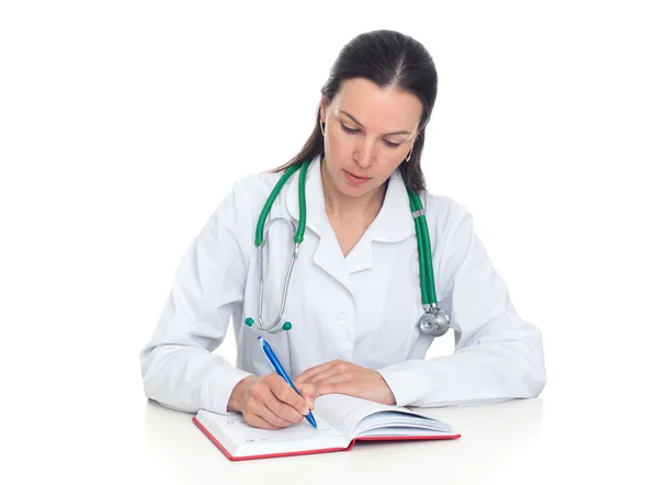 Female doctor takes notes in her notebook — Stock Photo, Image