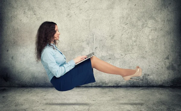 Woman hanging in the air with laptop — Stock Photo, Image