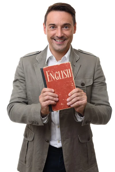 Sorrindo bonito homem detém Inglês livro didático — Fotografia de Stock