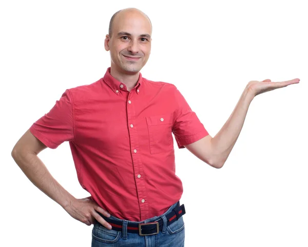 Smiling bald man presenting with his palm up — Stock Photo, Image