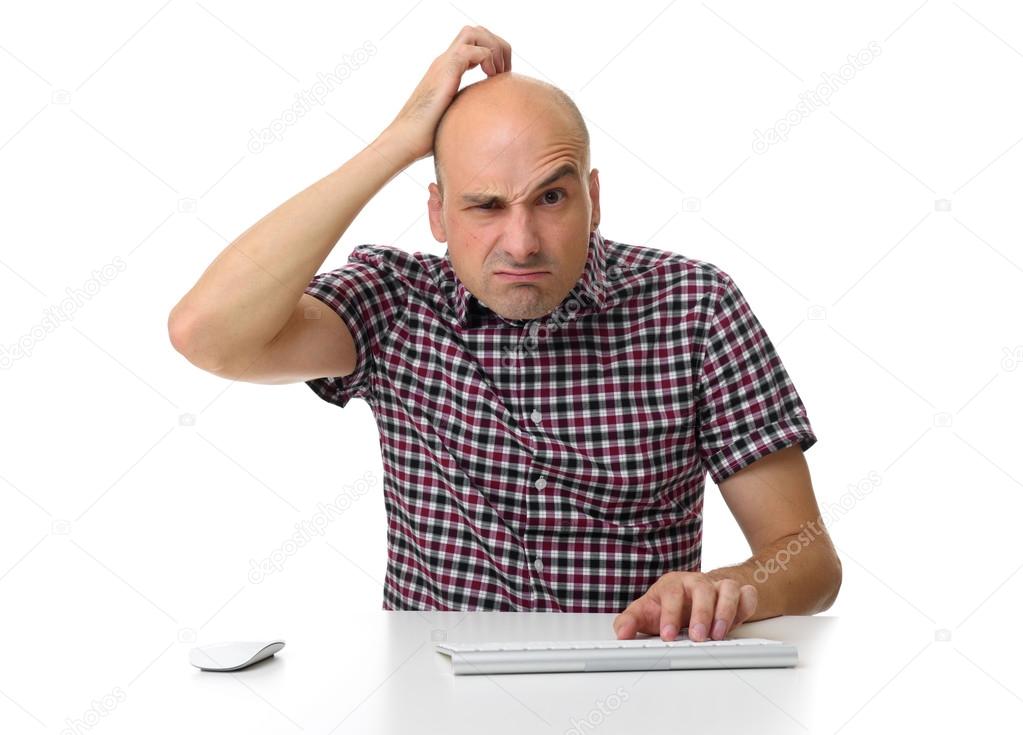 guy working on a computer and scratching his head