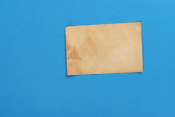 Old Weathered Yellow Paper Blue Background — Stock Photo, Image