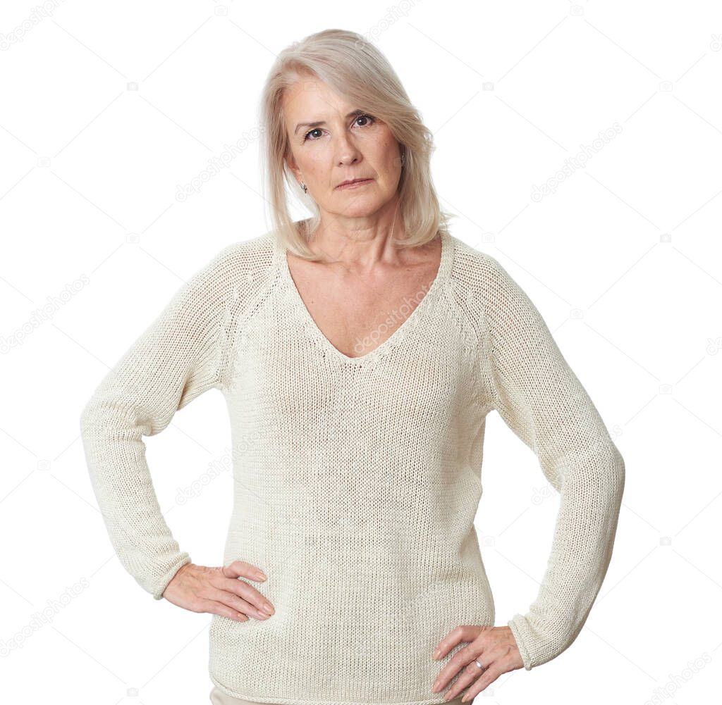 Portrait of a senior woman looking at camera. Old lady with hands on hips isolated on white background