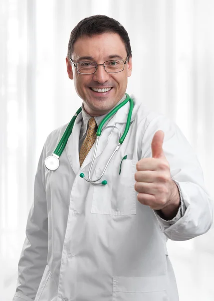 Friendly doctor smiling giving thumbs up — Stock Photo, Image