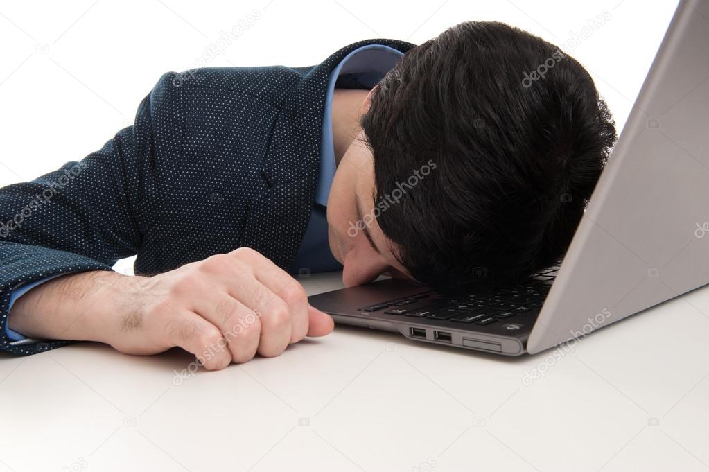 overworked businessman sleeping on his laptop