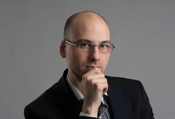 Thoughtful businessman wearing glasses — Stock Photo, Image