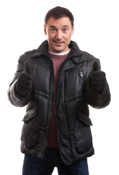 Handsome man in a down jacket showing his thumbs up — Stock Photo, Image