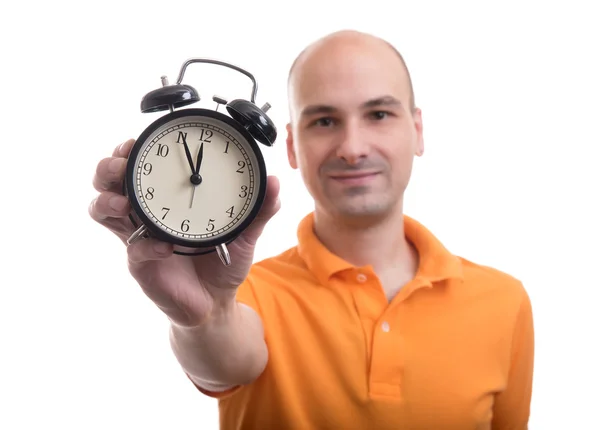 Man showing an alarm clock — Stock Photo, Image