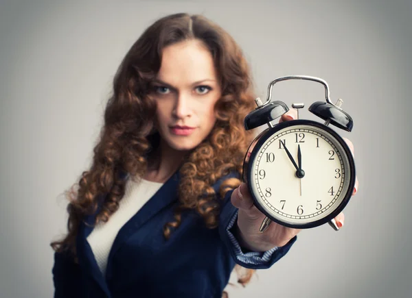 Girl showing alarm clock — Stock Photo, Image