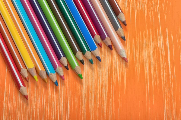 Colour pencils on orange background — Stock Photo, Image