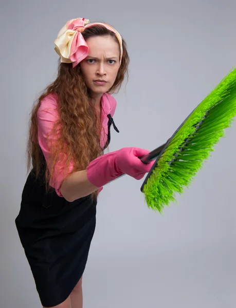 Angry housewife with broom — Stock Photo, Image