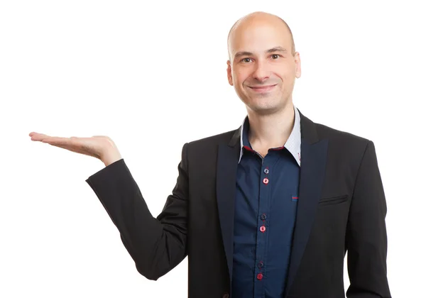 Young man displaying invisible product over white — Stock Photo, Image