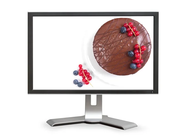 Pastel de chocolate en monitor de computadora —  Fotos de Stock