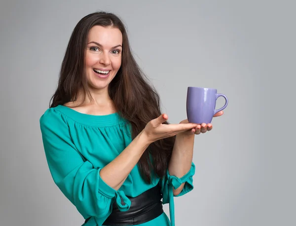 Beautiful woman holding cup of tea or coffee — Stock Photo, Image