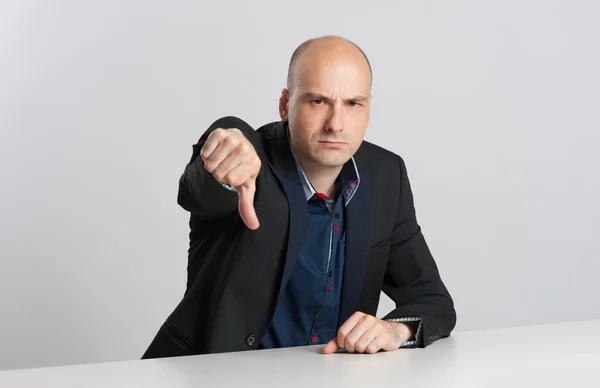 Angry businessman shows his thumb down — Stock Photo, Image