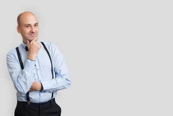 Bald man wearing bow tie and suspenders — Stock Photo, Image