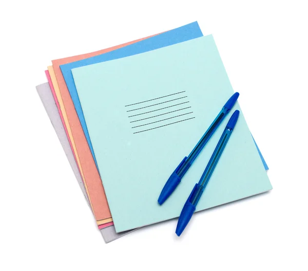 Exercise books and pens on a white background — Stock Photo, Image