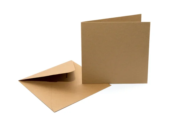 Brown envelope with a blank card over white — Stock Photo, Image