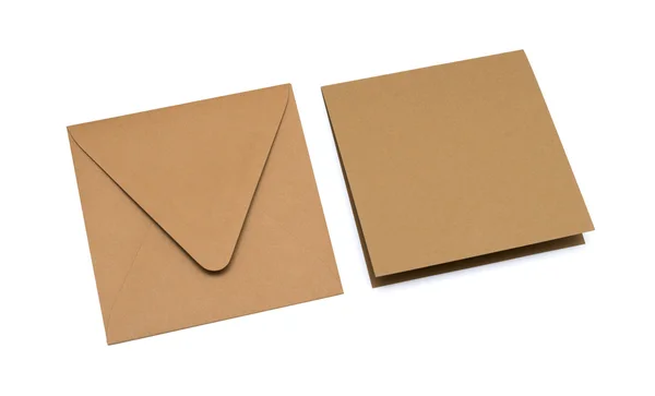 Brown envelope with a blank card over white — Stock Photo, Image