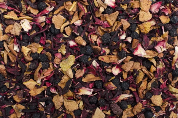 Aromatic black dry tea with fruits and petals, isolated on white — Stock Photo, Image