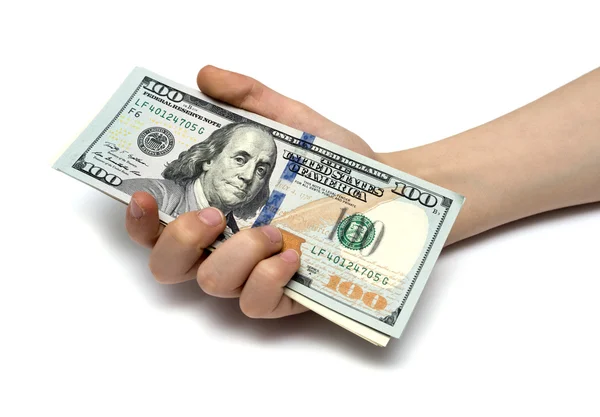 Mão de criança e pilha de dinheiro novo dólares americanos isolados em um branco — Fotografia de Stock