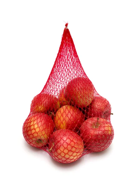 El montón de manzanas empaquetadas en la red roja — Foto de Stock