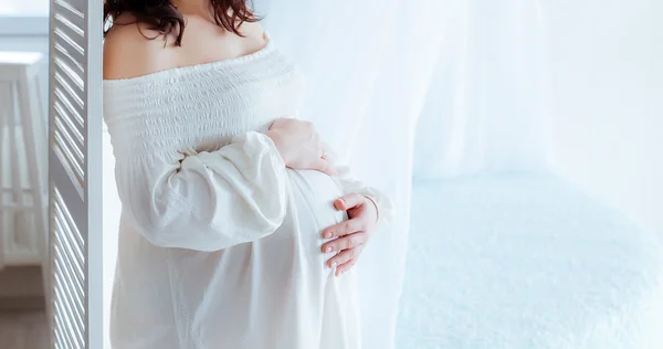 Beautiful soft and sensual pregnant girl in white